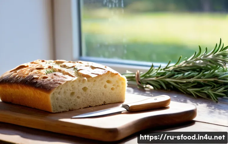 이탈리아 포카치아 샌드위치 조리법 - A rustic Italian kitchen scene featuring a freshly baked focaccia bread on a wooden board, topped wi...